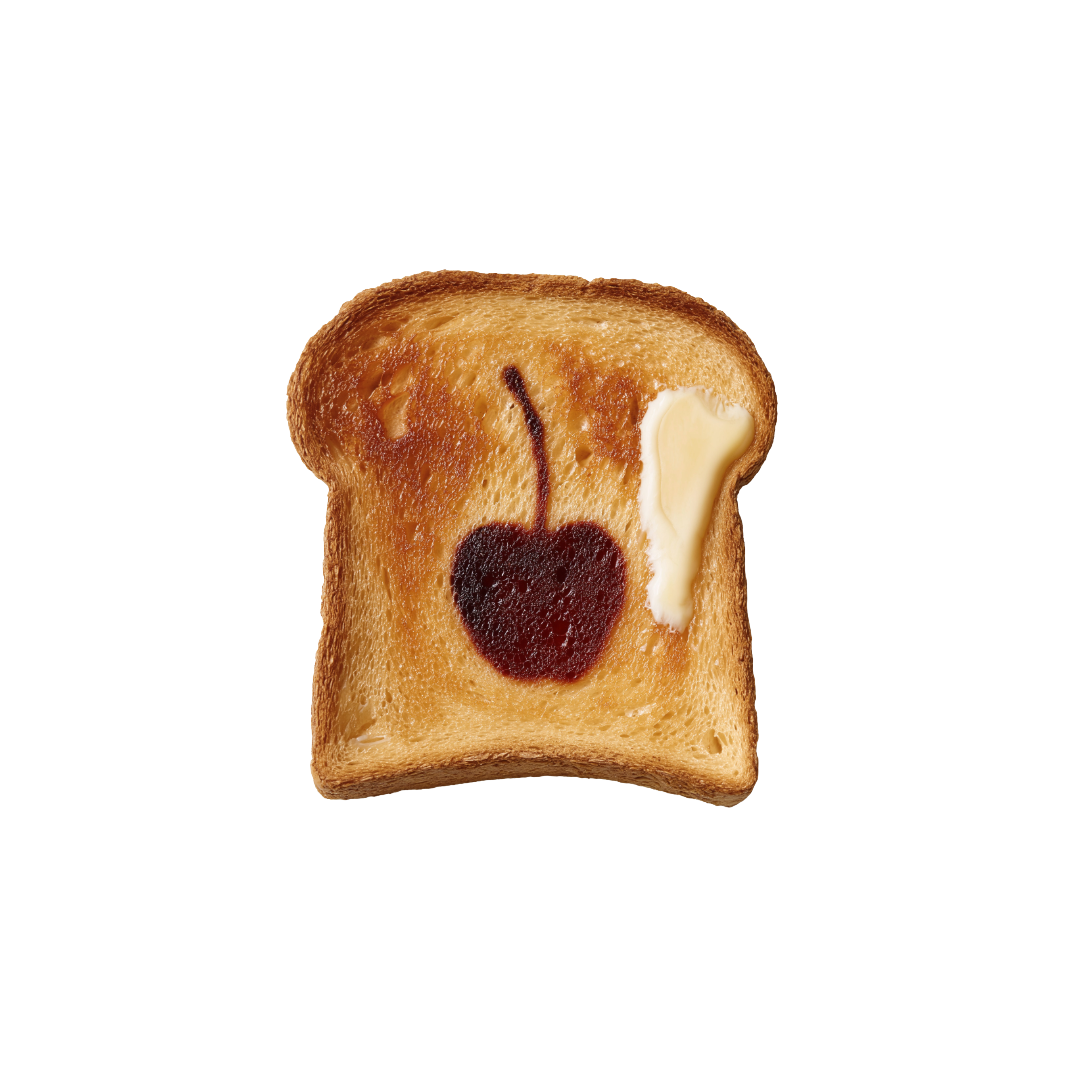Toast with a cherry design toasted into the bread and a pat of butter on a white background